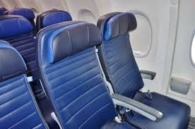 United Airlines Economy Class seats with blue upholstery, showcasing the standard seating arrangement.